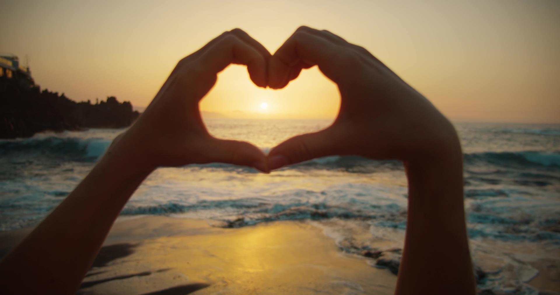 Hands_Showing_A_Heart_Symbol_At_Sunset_